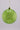 Green speckled Christmas ornament with gold chain on a gray background
