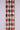 Textile with a diamond pattern in red, black, and beige on a white background