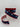 Spool of ribbon with white stars on navy and red trim, partially unrolled