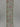 Reverse side of floral ribbon showing muted pink and green pattern on sage background
