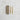 Set of three white candles with gold studs on a textured light gray surface