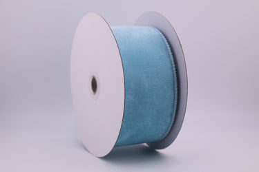 Spool of blue ribbon on a gray background
