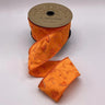 Bright orange dupion ribbon with floral embroidery and sequin accents on spool. 2.5 inches wide by 10 yards long.