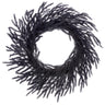Front of 24-inch black flocked willow pine wreath with layered wispy branches and a full circular silhouette