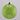 Green speckled Christmas ornament with gold chain on a gray background