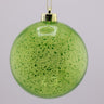 Green speckled Christmas ornament with gold chain on a gray background
