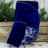 Blue velvet ribbon with floral pattern on a wooden surface