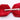 Red bow tie with a silver clip on a white background