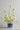 Blue ceramic sardine pot used as a vase with white flowers on a marble surface