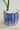 Close-up of blue hand-painted ceramic sardine pot with raised fish texture and white stones