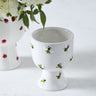 Buzzy ceramic compote planter with hand-painted bumble bee details and speckled white finish