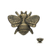 An antique bronze bee-shaped bottle opener, shown from a front-facing perspective on a solid white background, with a smaller bee image in the bottom right corner showing the back of the bottle opener.