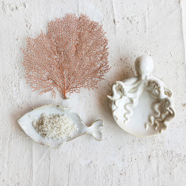 White stoneware octopus dish with sculptural tentacles and reactive glaze finish