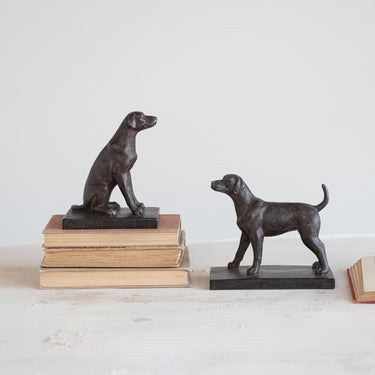 Black resin dog bookends set displayed separately on a shelf with books