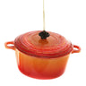 Cody Foster Orange Dutch Oven Ornament featuring a glass miniature Dutch oven with an orange-red finish, side handles, lid, and glitter accents.