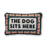 Dog Sits Here needlepoint pillow front view with dog bone border, bold black text, and blue-gray background
