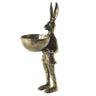 Brass-gold metal E+E Eric Hare dish stand holding a small decorative bowl, styled as a whimsical storybook-inspired tabletop accent