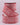 Red and white speckled ribbon on a light pink background