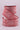 Red and white speckled ribbon on a light pink background