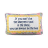 Sharpest Tool needlepoint pillow front view with ivory text panel, floral border, and pink piping