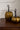 Antiqued gold metal pumpkins styled on a moody fall dining table