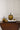 Large gold metal pumpkin styled on books with coordinating fall decor accents