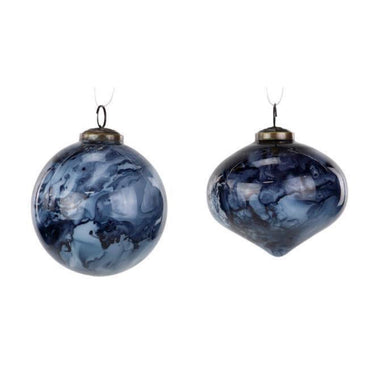 Close-up of two navy and white marbled glass ornaments—round and onion shaped—with vintage metal tops.