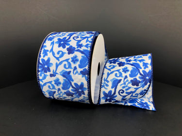Roll of blue floral ribbon on a black background
