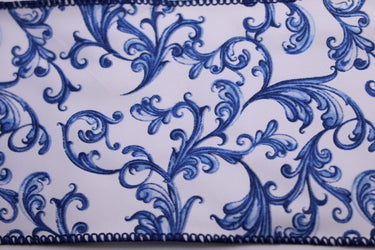 Decorative blue scroll pattern ribbon on white fabric close-up