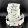 Spool of white ribbon with love and heart design partially unrolled