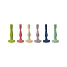 Six assorted cast iron taper candle holders in green, coral, cream, lavender, blue, and mint on white background