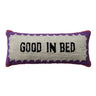 • Front view of Good In Bed cotton tufted lumbar pillow with cream center, black text, purple border, and pink trim